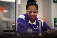 Student sitting with test tube in front of them